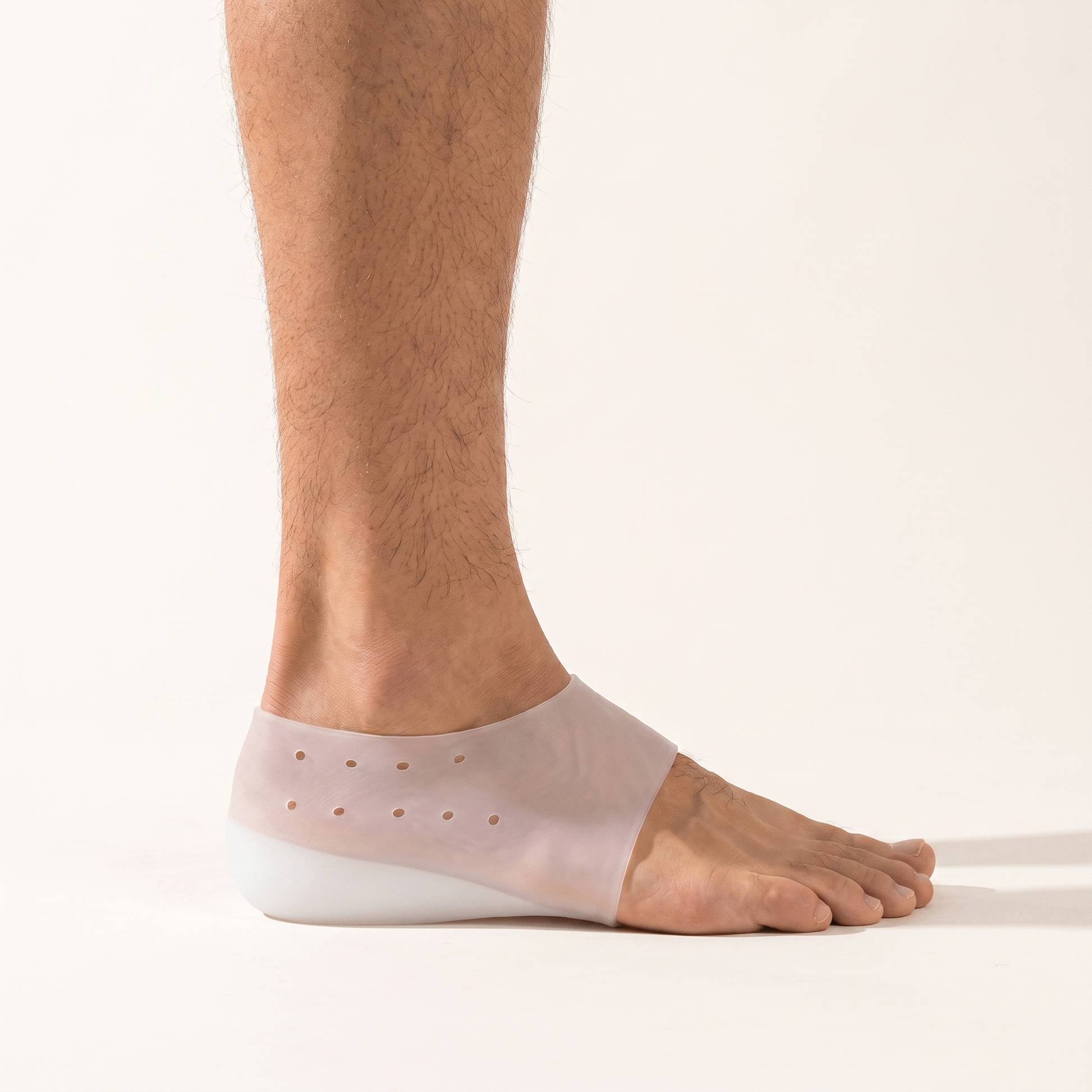 The ELVO heel lift worn on a bare heel, seen from the side